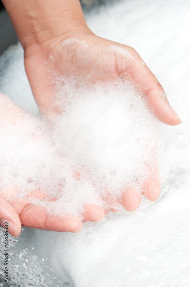 washing hands with soap under running water