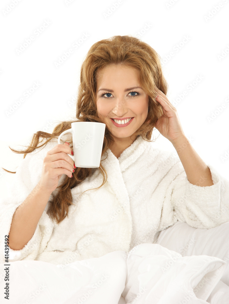 A young and happy Caucasian woman holding a white cup A young and happy Caucasian woman holding a white cup