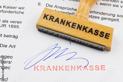 Holzstempel auf Dokument: Krankenkasse photo