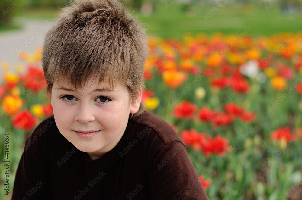 Portrait of a boy on a background of tulips Portrait of a boy on a background of tulips