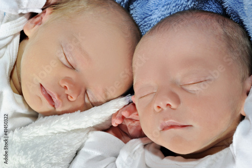Adorable twins sleeping together