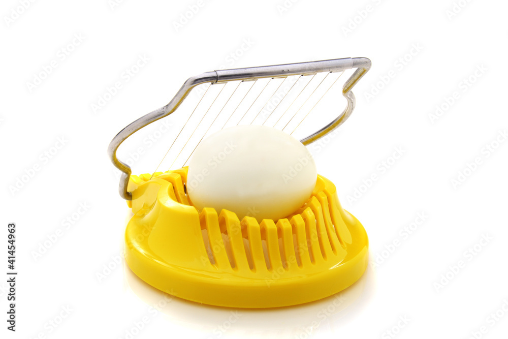 Boiled egg in the egg slicer. Boiled egg in the egg slicer.