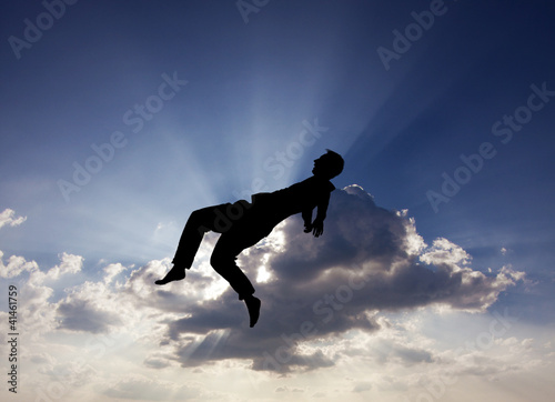 silhouette of man jumping in sky