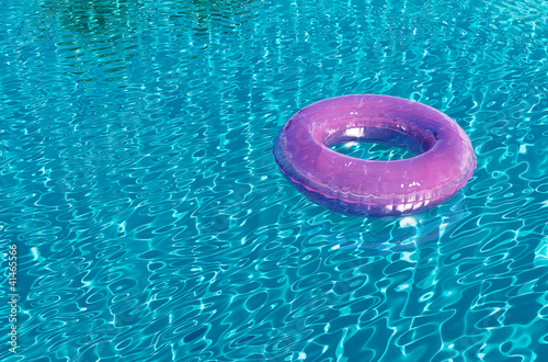 Pink flow ring in swimming pool, lazy summer holiday