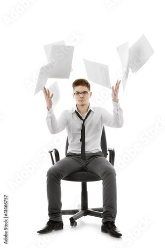 Young man throwing paper