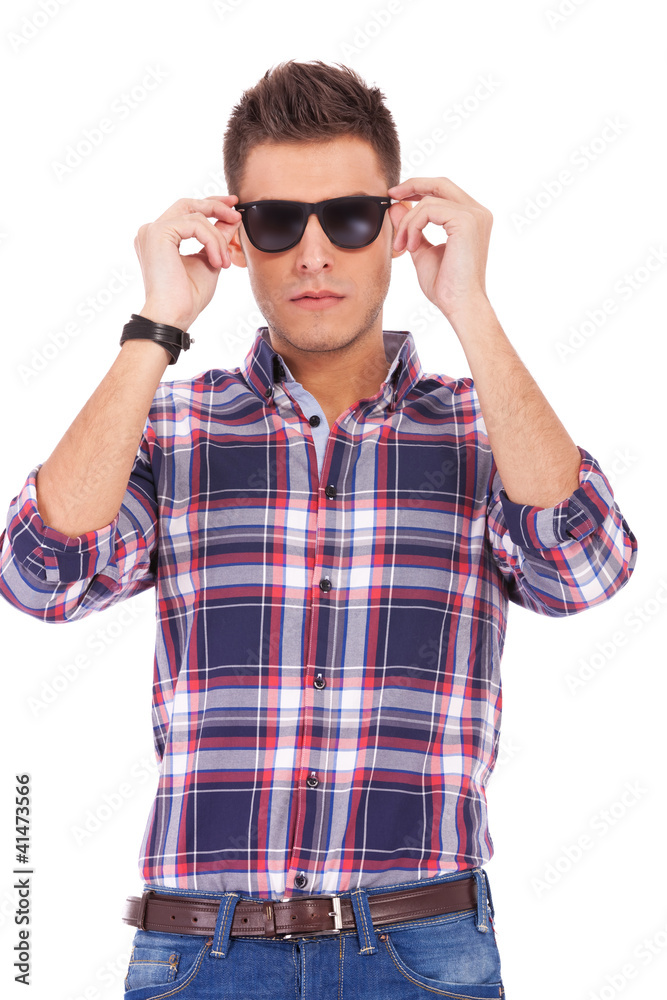 man putting sunglasses on man putting sunglasses on