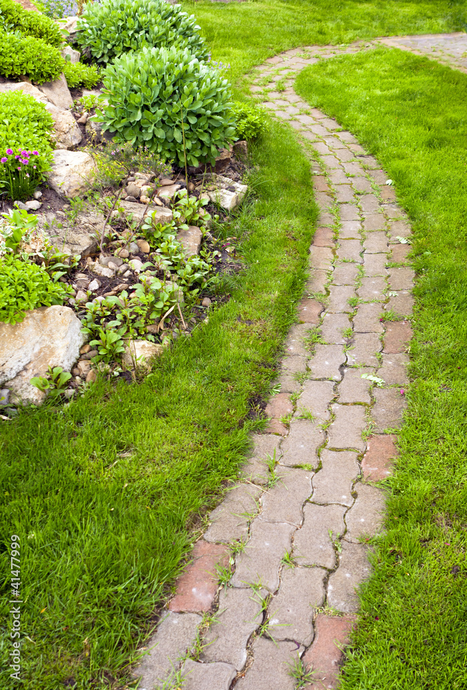 Garden walkway meanders in the grass.