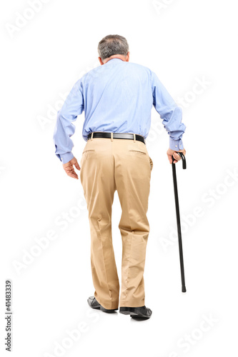 Full length portrait of a senior man with cane walking