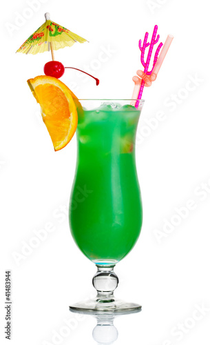 Green alcohol cocktail with orange slice and umbrella isolated