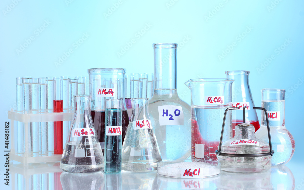 Test-tubes with various acids and chemicals  on blue background