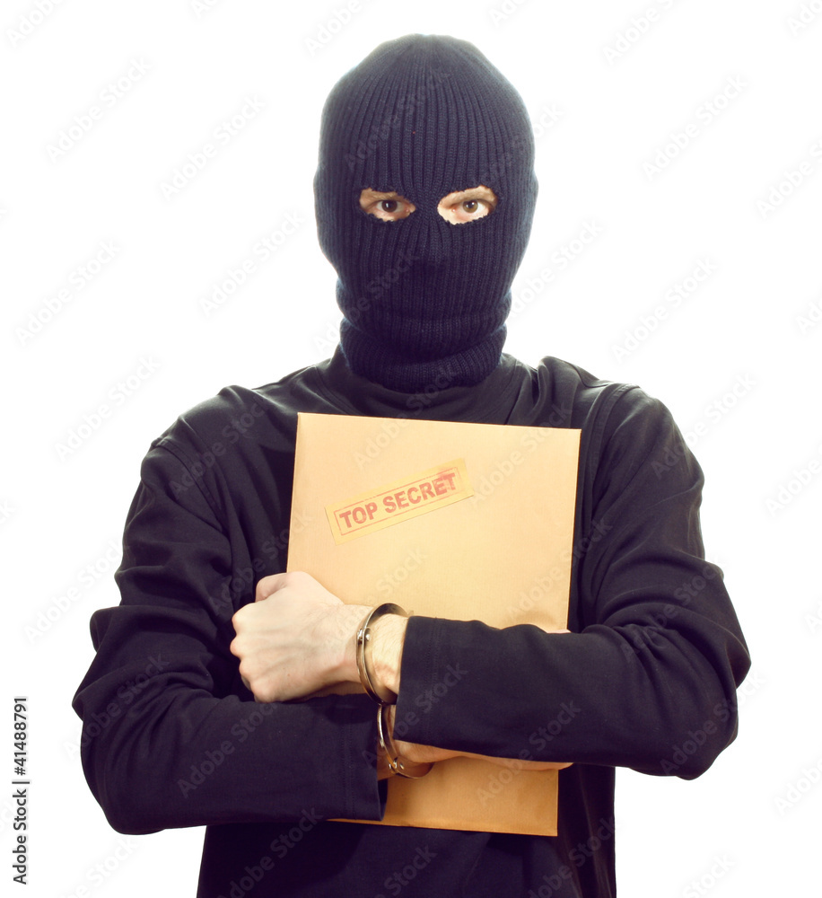 Bandit in black mask in handcuffs with top secret envelope Bandit in black mask in handcuffs with top secret envelope