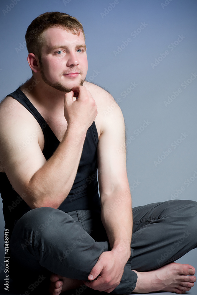 Muscular young man on dark background Muscular young man on dark background