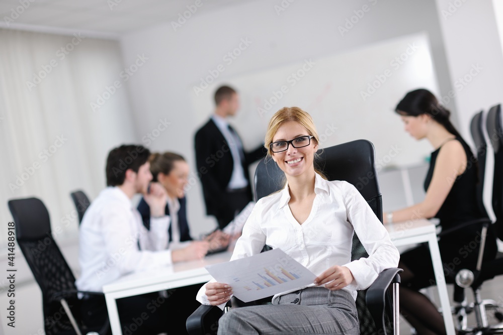 business woman with her staff in background business woman with her staff in background