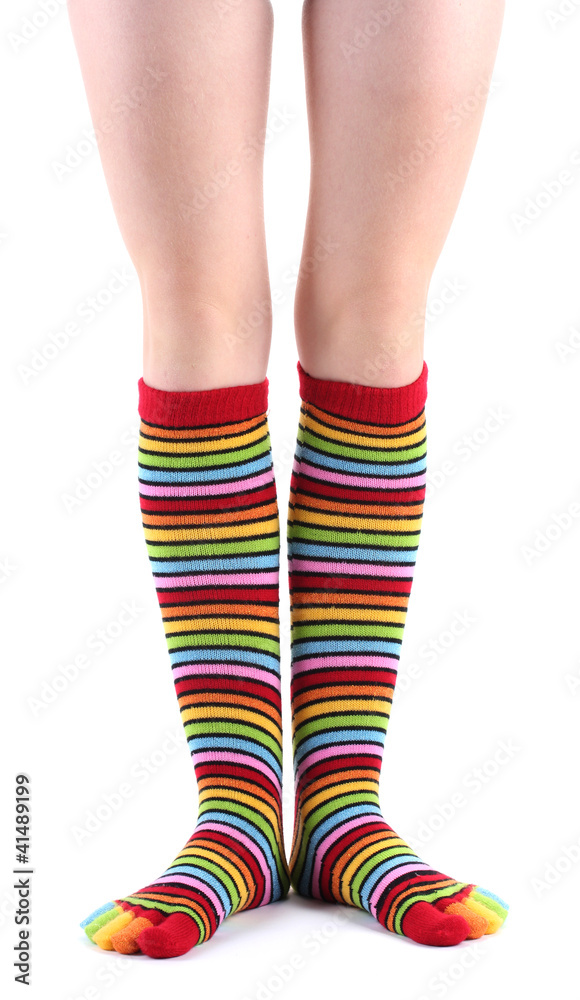 female legs in colorful striped socks isolated on white female legs in colorful striped socks isolated on white