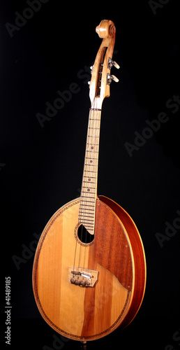 Retro kobza- Ukrainian musical instrument on black background photo