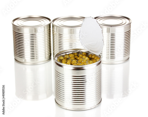 Open tin can of peas and closed cans isolated on white