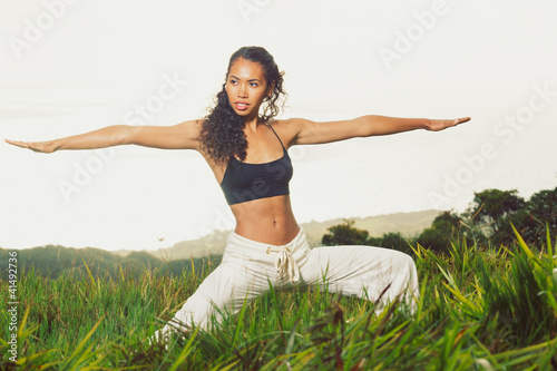 Beautiful Woman Practicing Yoga Outside in Nature