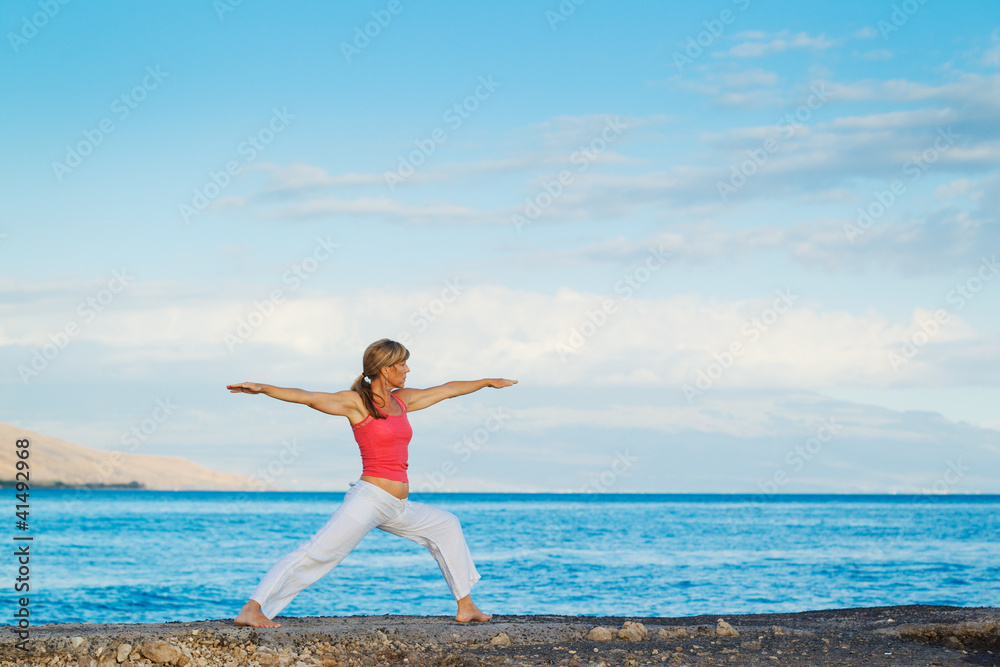 Beautiful Yoga woman Practicing Yoga by the Ocean Beautiful Yoga woman Practicing Yoga by the Ocean