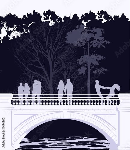 Young people walking across the bridge in the park