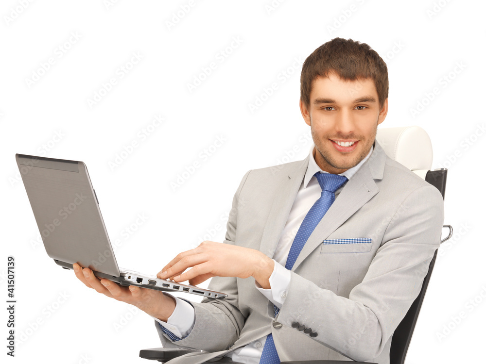 young businessman sitting in chair with laptop young businessman sitting in chair with laptop