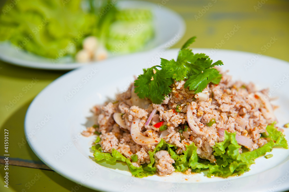 Larb chicken salad.Thai food with chicken, lime, chili, herbs Larb chicken salad.Thai food with chicken, lime, chili, herbs