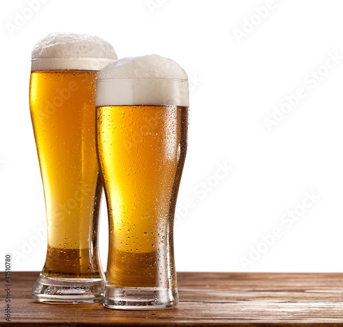 Two glasses of beers on a wooden table. #41510780