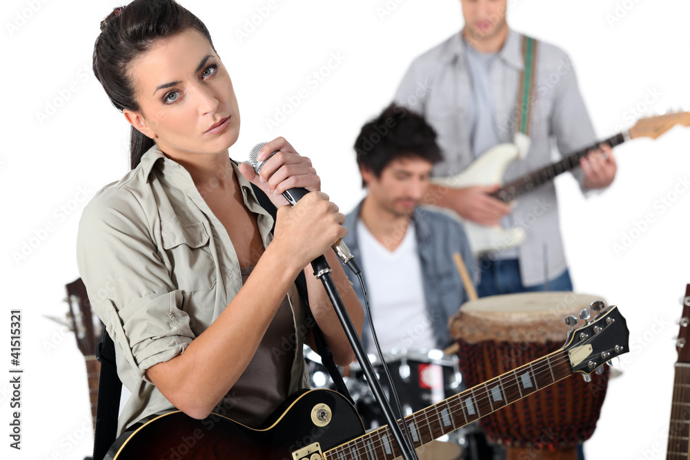 singer with guitar and microphone and male musicians singer with guitar and microphone and male musicians