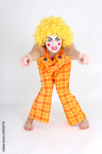 Clown in colourful costume showing hands