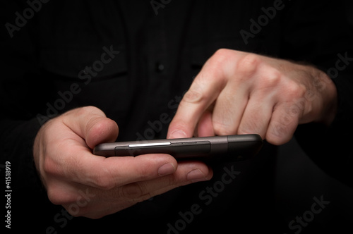Man typing a text message on a smartphone © Bits and Splits