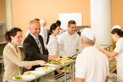 Obraz na płótnie Business colleagues cook serve lunch canteen food w salonie
