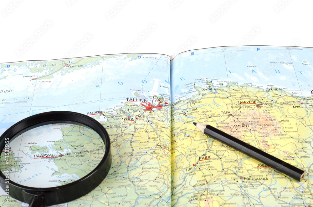 Magnifying Glass and pencil on the map Magnifying Glass and pencil on the map