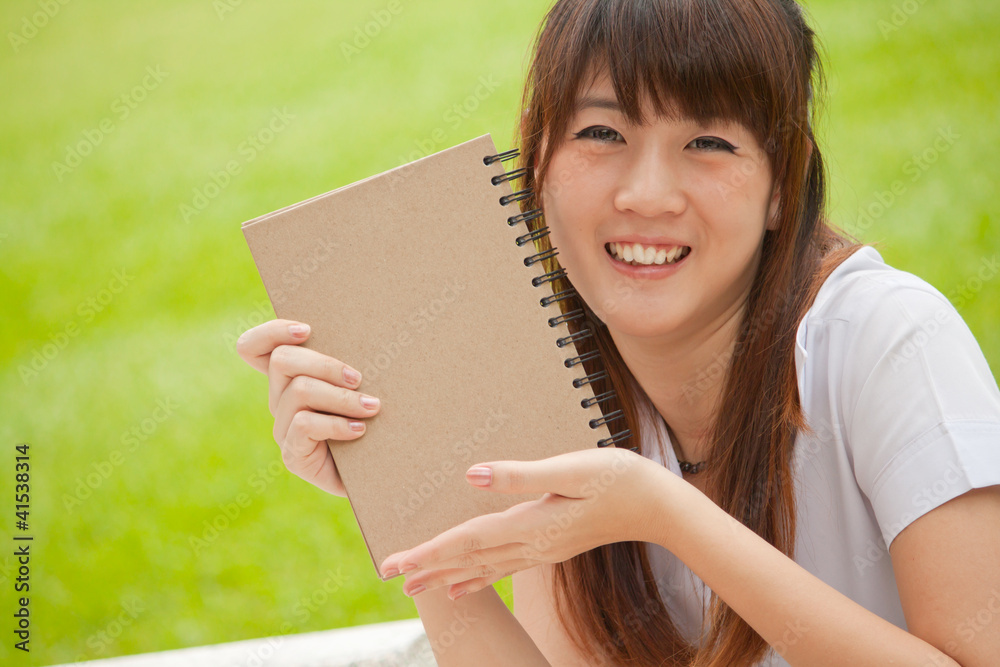 Smiling young woman with blank note Smiling young woman with blank note