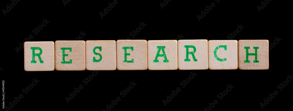 Green letters on old wooden blocks (research)