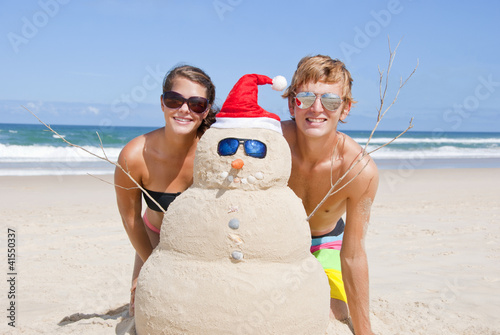 Couple having fun at beach with sandman