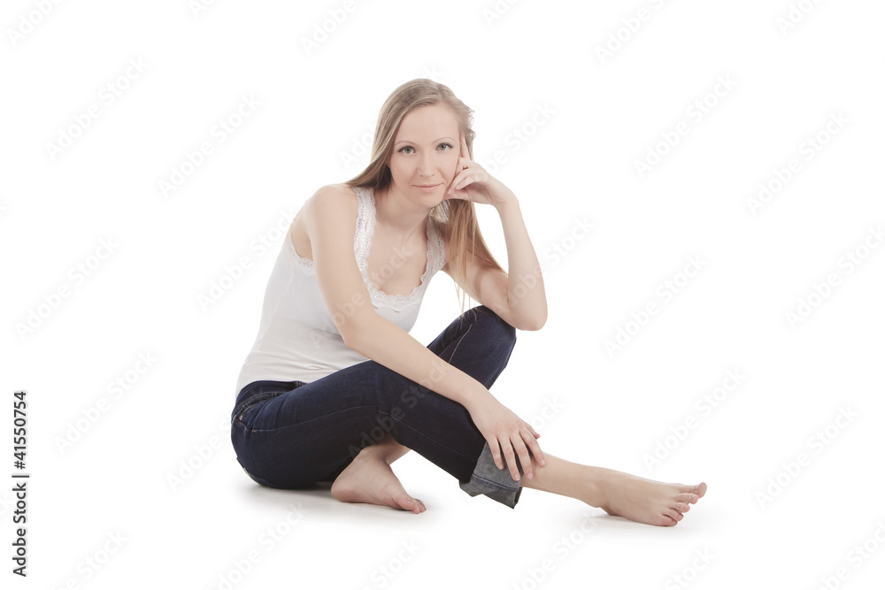 beautiful young woman sitting on a white floor barefoot beautiful young woman sitting on a white floor barefoot