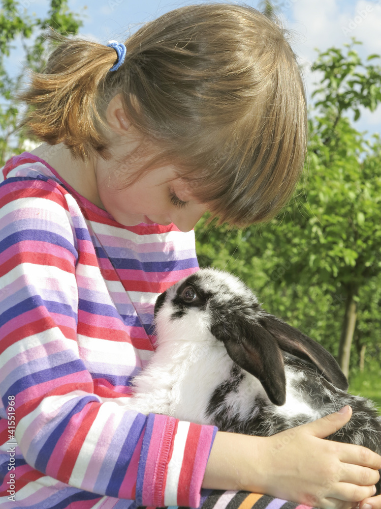little girl and little rabbit in the garden little girl and little rabbit in the garden