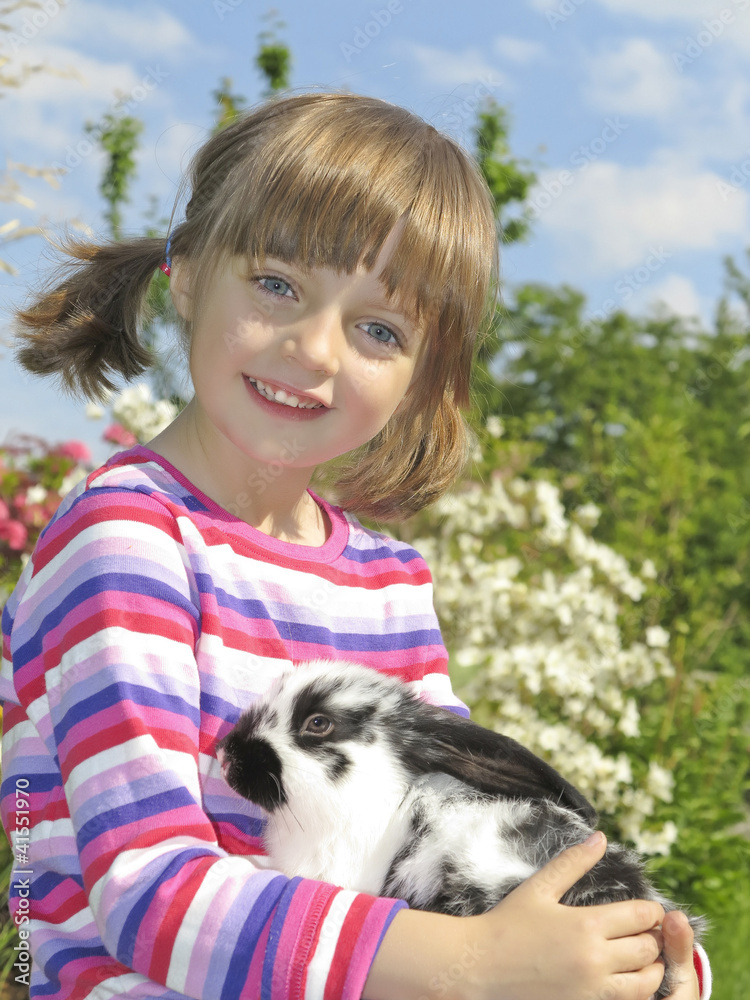 little girl and rabbit in the garden little girl and rabbit in the garden