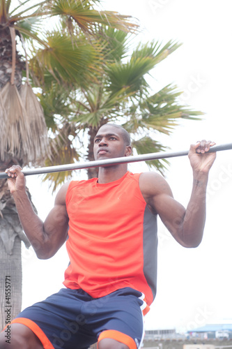 portrait of an African American athlete doing pullups