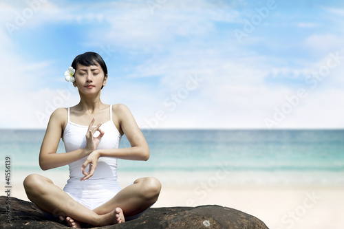 Beautiful Asian Woman Meditating at Beach