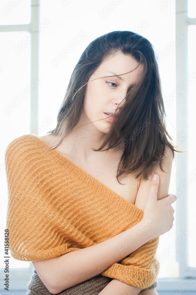 Portrait of pretty brunette girl in window Portrait of pretty brunette girl in window