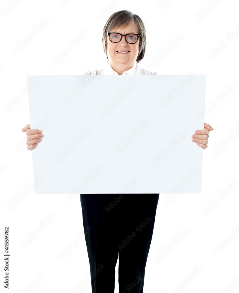 Senior businesswoman posing with blank placard Senior businesswoman posing with blank placard