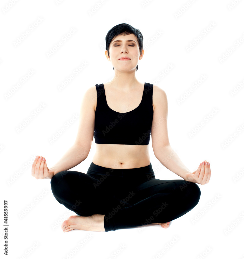 Youung woman meditating in lotus pose