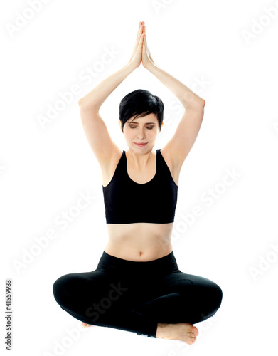 Beautiful blonde girl meditating in black