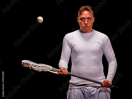 Lacrosse player isolated on black background