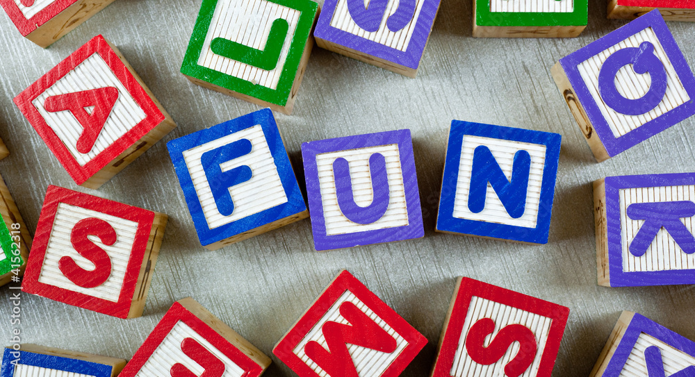 Wooden blocks forming the word FUN in the center Wooden blocks forming the word FUN in the center