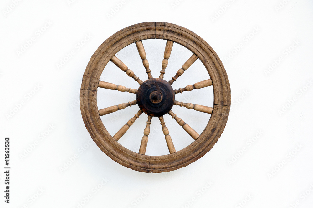 Vintage Spinning Wheel on White Wall