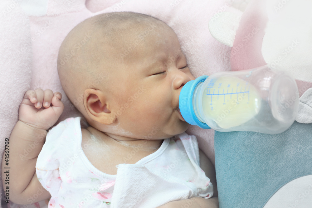 face of infant drinking mother milk from bottle face of infant drinking mother milk from bottle