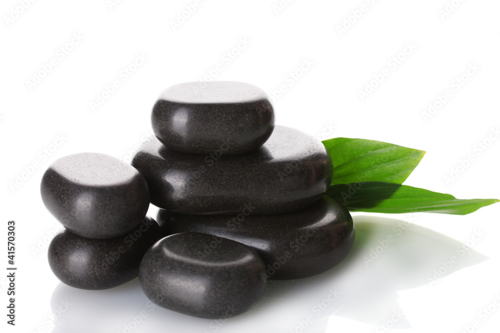 Spa stones and green leaves isolated on white Spa stones and green leaves isolated on white