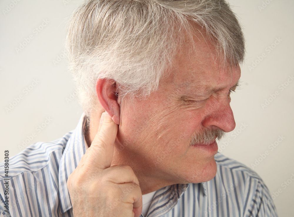 senior man suffers from pressure behind his ear senior man suffers from pressure behind his ear