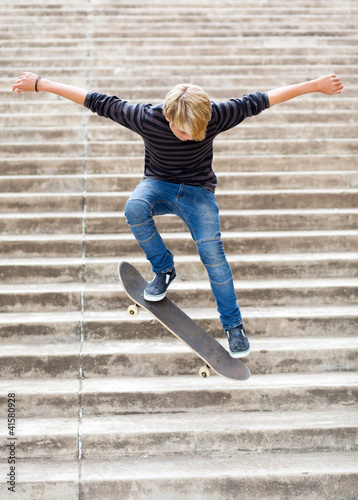 Fototapeta Naklejka Na Ścianę i Meble -  teen boy skateboarding on stairs